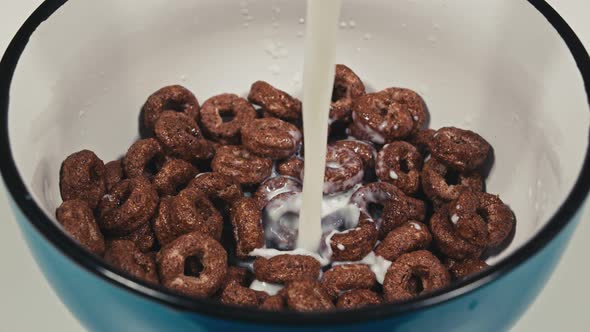 Milk Being Poured Over Breakfast Cereal Hoops