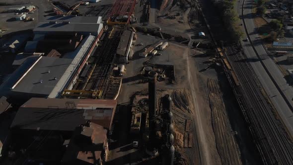 Beautiful turning aerial of an old steel mill near Pueblo, Colorado before complete demolition.  Lar