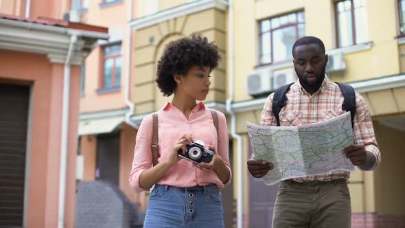 Young Tourist Couple With Map and Photo Camera, Choosing Direction, Travel