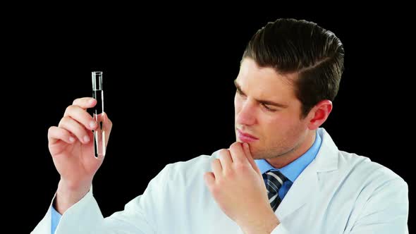 Doctor using digital screen while examining chemical in test tube