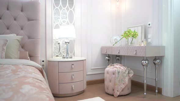 Luxury bedroom for a girl with a beautiful interior in pastel pink shades with a dressing table