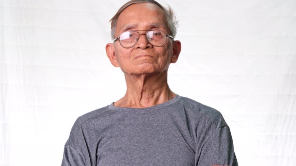 Asian senior man smiling happily at home.