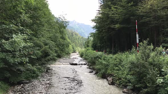 Wide shot of a river in the German alps near Oberstdorf. Mountains in the background.