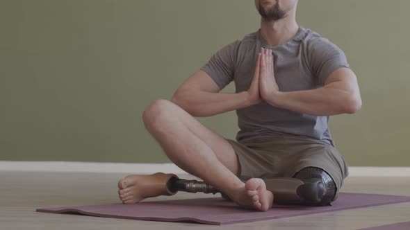Man with Prosthetic Leg Practicing Yoga Indoors