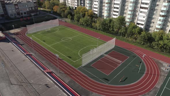 Stadium, basketball court and treadmills in the yard in the city 01