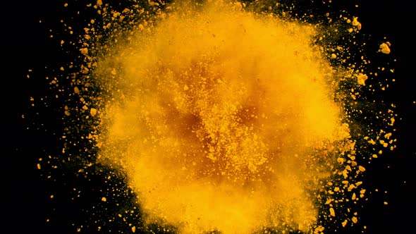 Super Slow Motion Shot of Rotating Yellow Powder Expolosion Isolated on Black Background at 1000Fps
