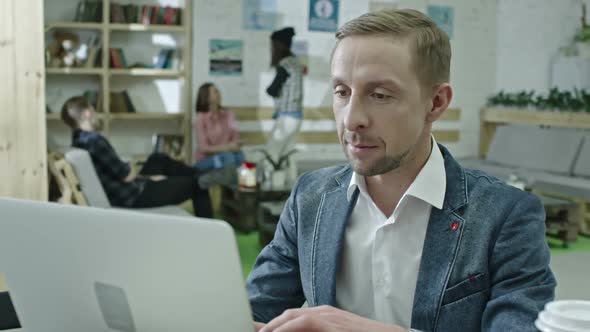 Hipster Businessman Typing on Laptop