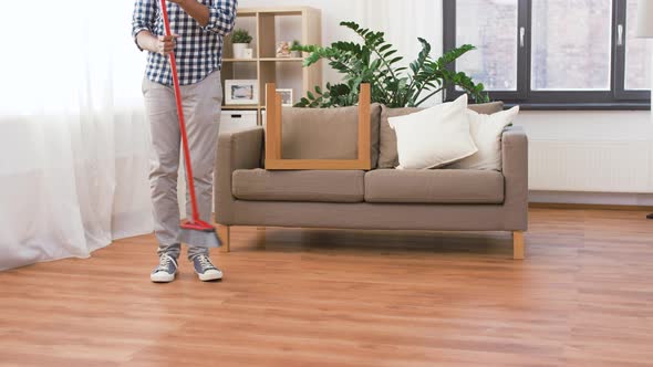 Man with Broom Cleaning and Having Fun at Home 52