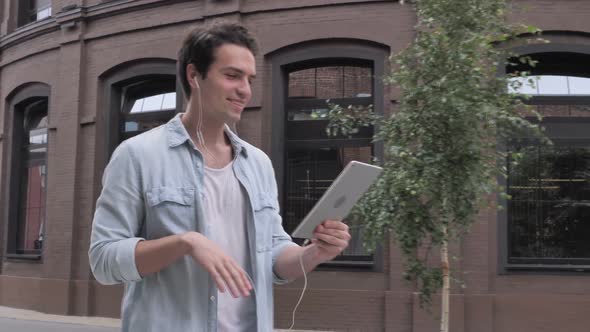 Online Video Chat on Tablet By Walking Man on Street