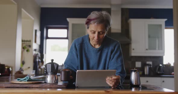 Senior woman relaxing alone at home