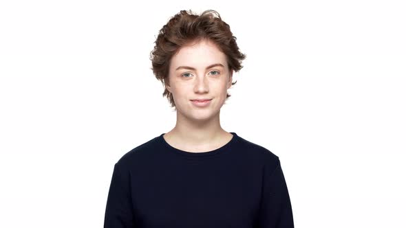 Portrait of Positive Woman Wearing Casual Posing on Camera and Smiling Broadly Isolated Over White