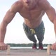 Muscular athletic young man doing pusр ups on the parallettes bar. Sport and health care concept - VideoHive Item for Sale
