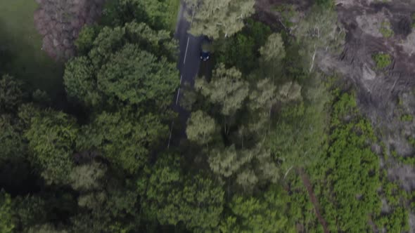 Drone aerial tracking birds eye view shot of car in countryside