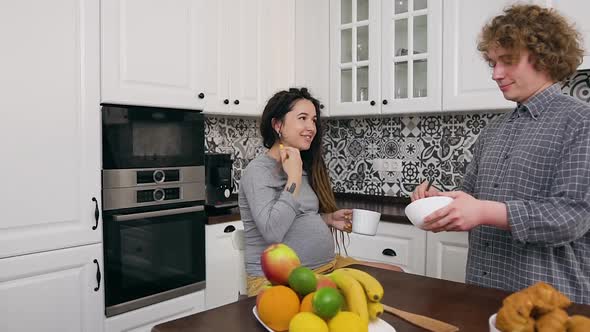 Married Couple which Being in the Contemporary Kitchen where Curly Husband Preparing Breakfast