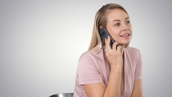 Portrait of Smiling Young Woman Making a Call Sitting On