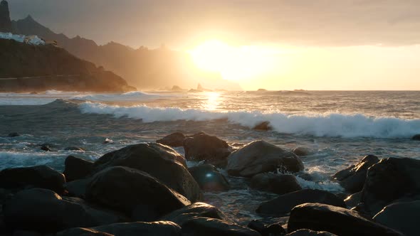 Ocean Waves Crash on Rocks and Spray in Beautiful Sunset Light at Benijo Beach in Tenerife, Canary