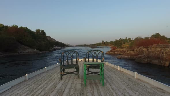 Two chairs and table on the roof of boat