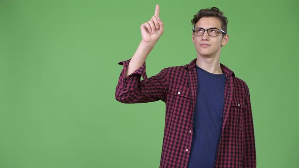 Young Handsome Teenage Nerd Boy Pointing Finger Up