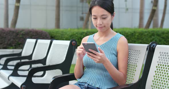 Young Woman use of mobile phone in the park
