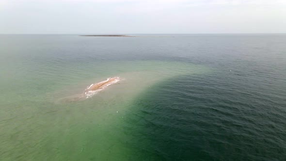 Small Uninhabited Sand Island in Ocean Reef,  Drone High Ungraded Video