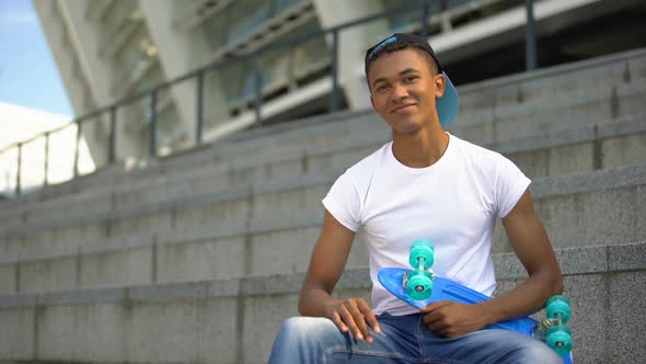 Mixed-Race Teenager With Skateboard Smiling Into Camera, Leisure Activity, Hobby