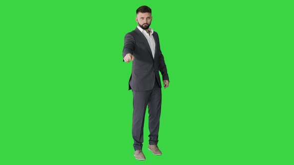 Businessman with a Beard Showing Gestures Finger Up, Thumbs Up on a Green Screen, Chroma Key.