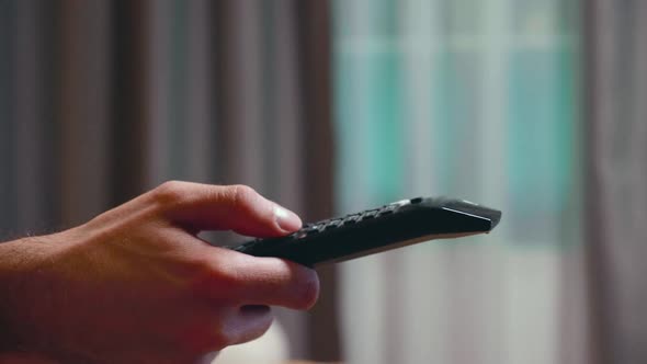 Close Up of Businessman Using Tv Remote Control