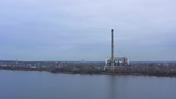 Aerial view of the Industrial Plant with Smoking Pipes near the City. Industrial zone. 