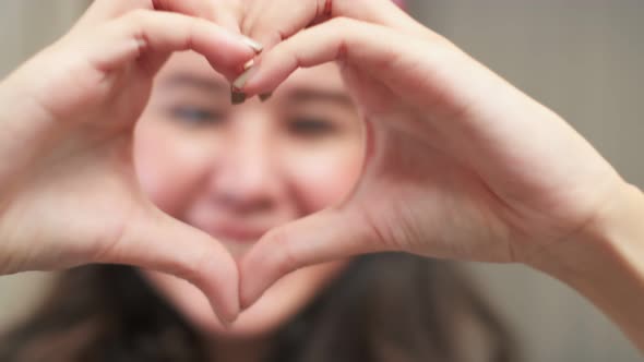 asian young beauty woman make heart shape hand gesture.