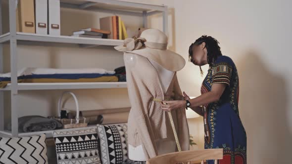 Female Dressmaker Working with Garment on Dress Form