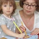 Elderly Woman with Little Girl Paint Goldfish on Paper with Colored Pencils - VideoHive Item for Sale