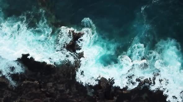 Aerial coastline view with wild beach and blue beautiful ocean water with waves