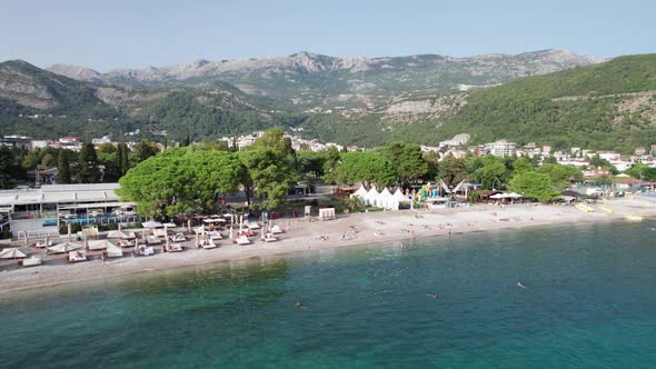 Aerial View Budva Beach By Sea with Sun Loungers and People Seashore Montenegro