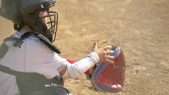 Boy plays catcher in a little league baseball game.