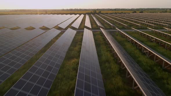 Aerial Drone View of Large Solar Panels at a Solar Farm at Bright Sunset in Early Winter