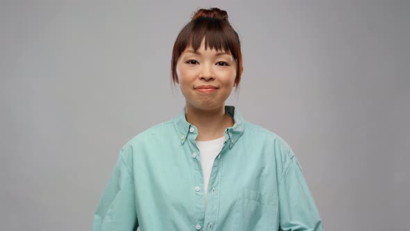 Asian Woman with Recycling Sign Showing Thumbs Up