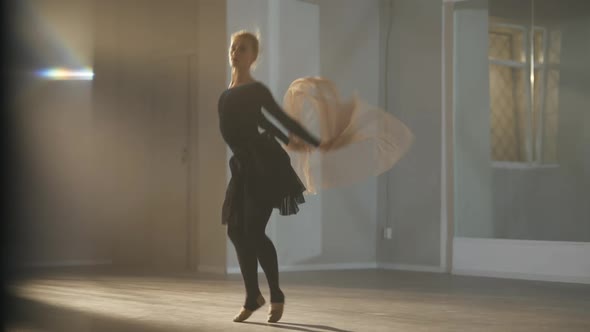 Wide Shot of Talented Slim Beautiful Caucasian Ballerina Jumping with Elegant Scarf in Hands in Slow