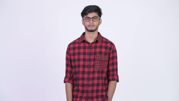 Young Happy Bearded Indian Hipster Man Pointing Up