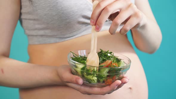 Smiling Pregnant Woman Eating Vegetable Salad