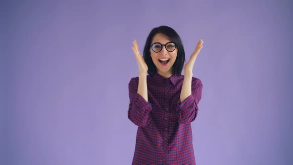 Portrait of Cheerful Girl Playing Hide-and-seek Smiling on Violet Background