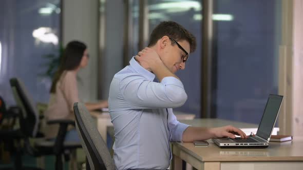 Young Man Massaging Numb Neck, Effects of Sedentary Work, Problems With Posture