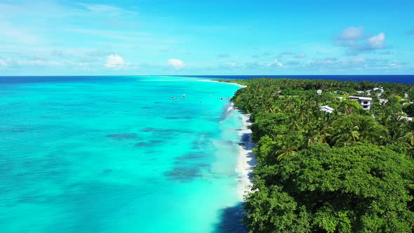 Daytime birds eye travel shot of a white paradise beach and blue water background in high resolution