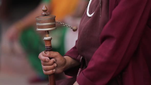 Buddhist monk spinning a prayer wheel in Kathmandu, Nepal.