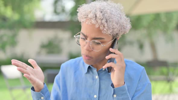 Portrait of Angry Young African Woman Talking on Phone