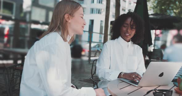 Two women discuss business at table