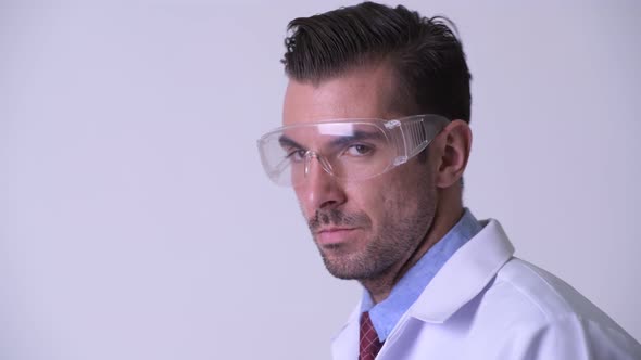 Profile View of Young Hispanic Man Doctor Wearing Protective Glasses