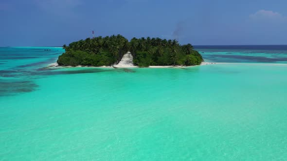 Aerial flying over texture of relaxing shore beach vacation by blue water with bright sand backgroun