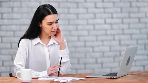 Asian Female Office Worker Having Problem with Document or Making Mistake