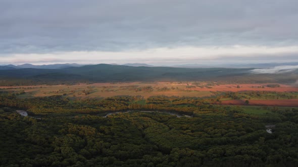 Aerial Drone View of Sunrise Over Misty River