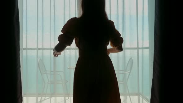 Young Travel Woman Running Opening Curtain Looking at Sea View Through Window